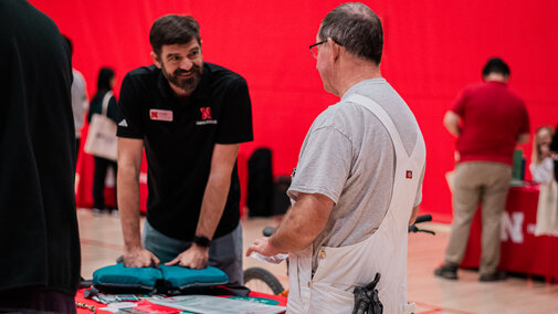 Vendor speaking with an employee at their booth