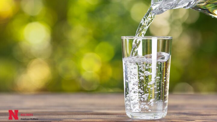 Pouring water into a clear glass