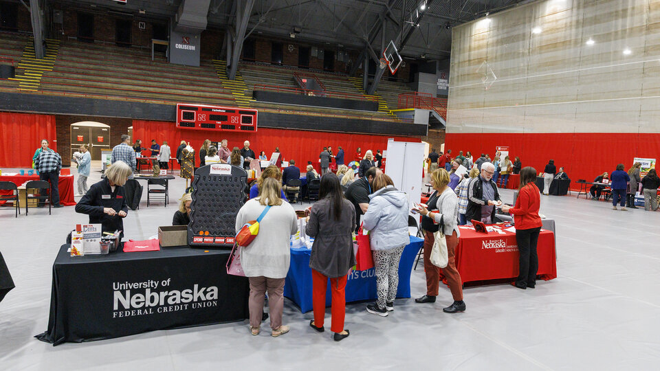 People stopping at wellness booths at wellness fair