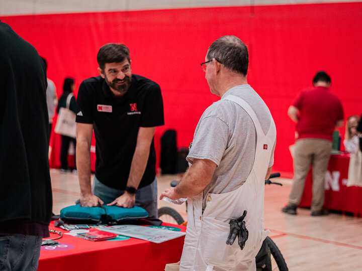 Vendor speaking with an employee at their booth